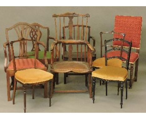 An 18th century and later Windsor comb back chair, altered, three open elbow chairs, three Victorian bedroom chairs, and an u