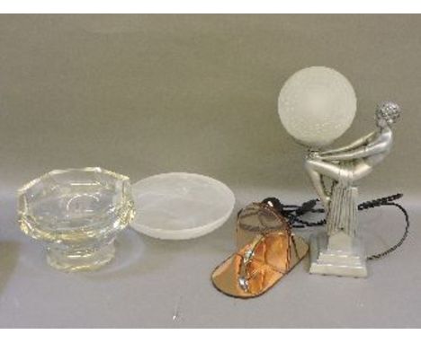 A Deco style table light, modelled as a figure holding a crazed globe shade, two bowls, and a pair of pink tinted glass booke