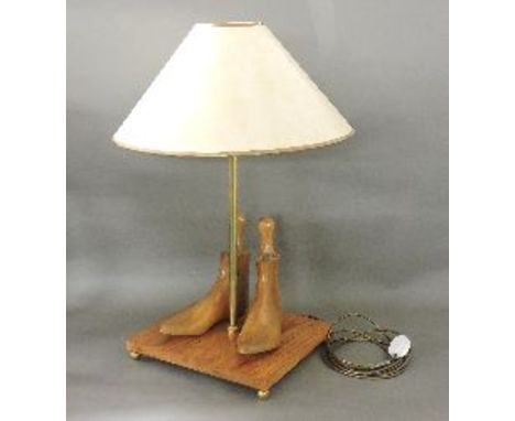 A modern table lamp shade, the base with a pair of applied shoe lasts, 75cm high