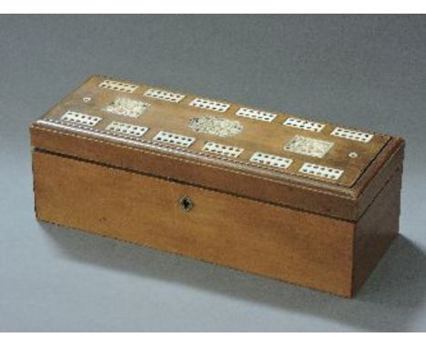 A sandalwood box, the hinged cover inlaid in ivory, with a cribbage board and three shaped and carved plaques, 21cm long