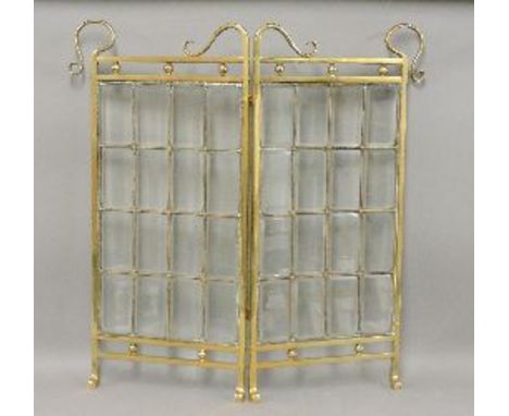 An Art Nouveau brass framed single fold fire screen, with bevelled glass panels, 76cm high, 75cm open