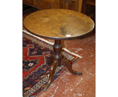 An 18th Century oak tripod table 67cm high, 64cm diameter 