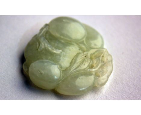 A white jade pendant carved as a group of fruits and fungi, 19th or first half of 20th century, with mutton fat inclusions, 4