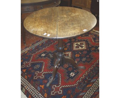 An 18th Century oak circular occasional tripod table 71cm high, 74cm diameter 