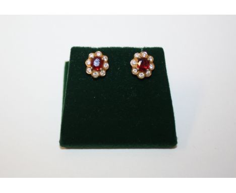 A pair of gold diamond and ruby cluster earrings, 2.6g in total 