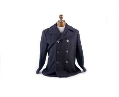 A U.S. Navy Wool Pea Coat  of regulation pattern together with three WW2 and later USN undress blue pull-over tops with insig