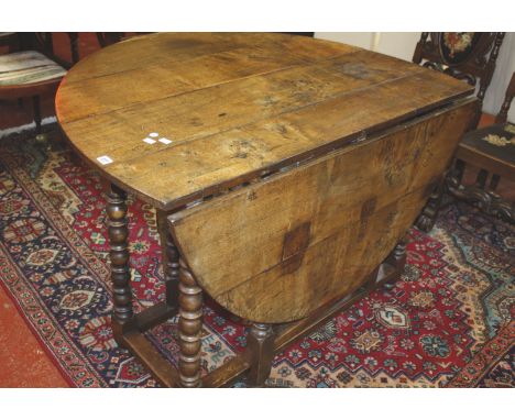 A 17th Century and later oak gate leg table 142cm wide 