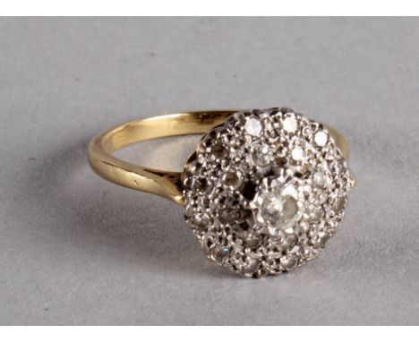 An 18ct gold and diamond cluster ring, the central small diamond surround by a circle of diamond clusters, illusion set, 4g 