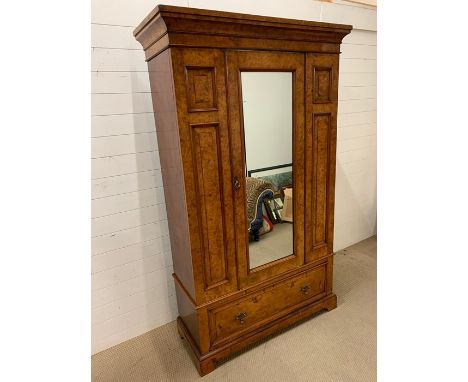 A Large Walnut veneered wardrobe with single mirrored door and large drawer on bracket feet (W 125 cm 207 cm H x 50 cm D)