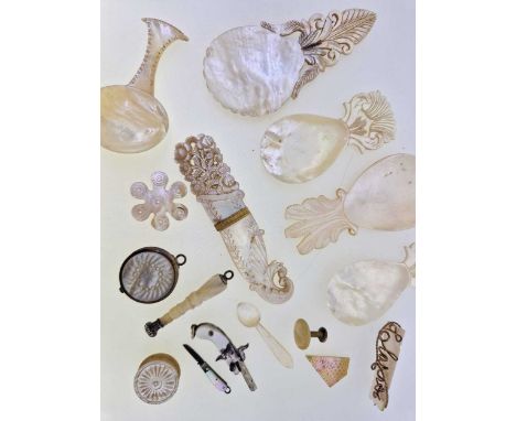 A collection of mother of pearl items including caddy spoons, vinaigrette, jewellery etc