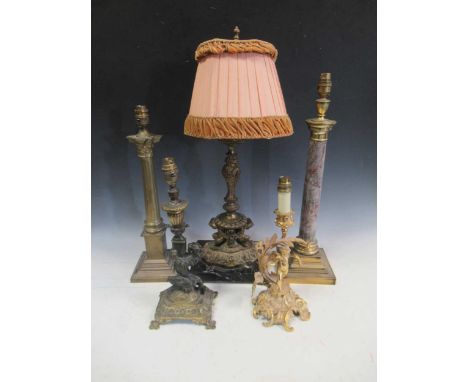 An early 20th Rococo style gilt metal figural table lamp, a rampant lion column lamp, a faux marble Doric lamp, a gilt metal 