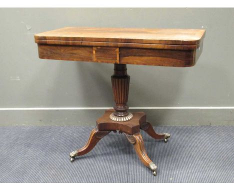 A Regency rosewood card table, the fold over top enclosing a green baize playing surface above a reeded column raised on four