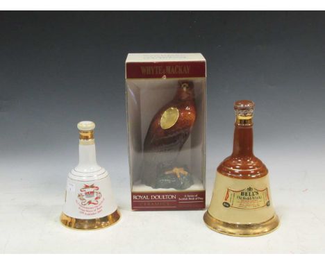 A Royal Doulton Whyte &amp; Mackay Golden Eagle whiskey decanter (boxed), together with a Bells commemorative whiskey decante