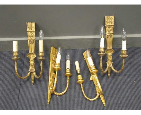 A set of four Neo-classical style gilt painted twin branch wall lights, 46cm hightwo are a lighter gilt tham the other two, a