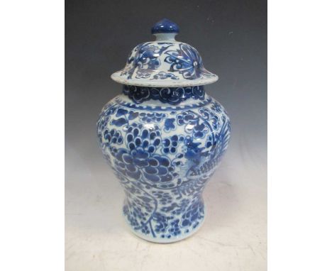 A blue and white lidded jar, in Kangxi style, decorated with a mythical bird, 34cm highChipping and rough areas to the rim of