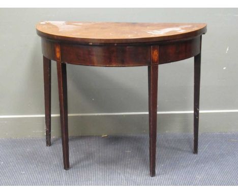 A late George III mahogany fold over top demi-lune card table on square legs 73 x 92 x 46cm (closed)