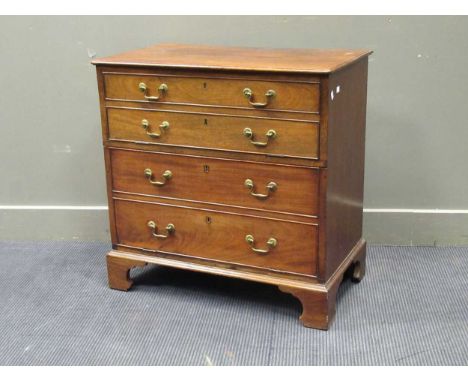 A Georgian style mahogany cabinet, with two fall front cupboard doors hidden by a four faux-drawer front on bracket feet, 79 