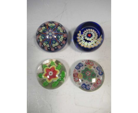 A Baccarat flower head small paperweight, 19th century, 5.4cm diameter; together with three other millefiori paperweights inc
