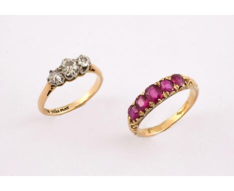 A RUBY FIVE STONE RING the five graduated oval-shaped rubies are set in yellow gold, size O, together with a diamond three st