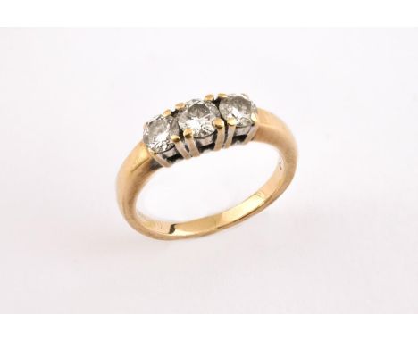 A DIAMOND THREE STONE RING set with three circular-cut diamonds in 18ct gold. Size K