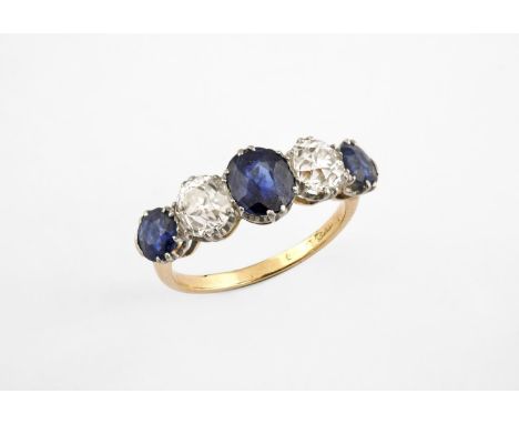 A SAPPHIRE AND DIAMOND FIVE STONE RING the oval-shaped sapphire is set with two circular-cut sapphires and two old circular-c