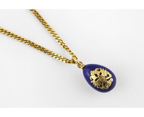 AN ENAMEL AND GOLD EGG PENDANT BY FABERGE the blue guilloche enamel egg mounted with gold lion mask decoration, limited editi