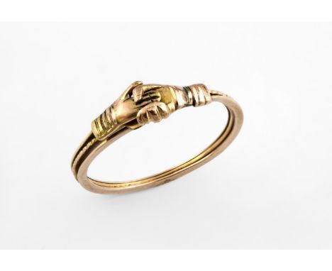AN EARLY 19TH CENTURY GOLD GIMMEL RING the three gold bands link together to form clasped hands and open to reveal a double h