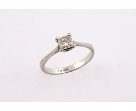 A DIAMOND SOLITAIRE RING the princess-cut diamond is set in platinum. Size K