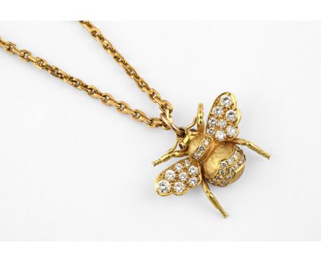 A DIAMOND AND GOLD BEE PENDANT set overall with circular-cut diamonds in 18ct gold, with cabochon ruby eyes, 2.8cm wide, on a