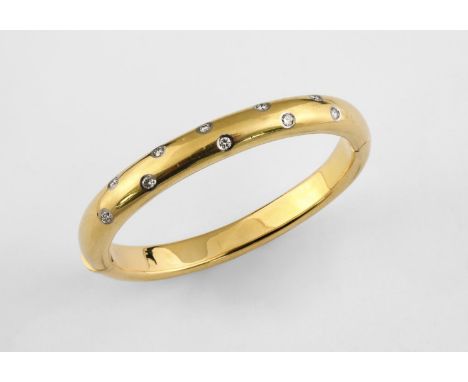 A GOLD AND DIAMOND HALF HINGED BANGLE the 18ct gold bangle mounted to one side with ten circular-cut diamonds, internal measu