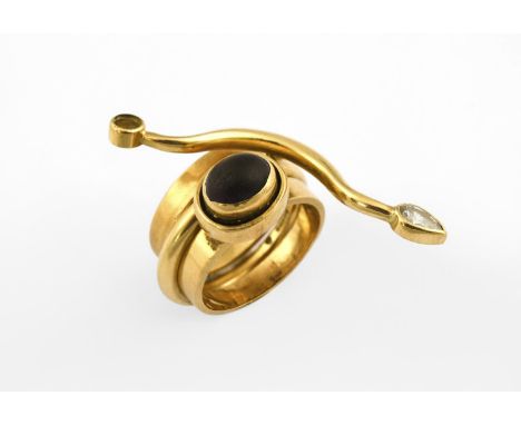 A GOLD, GARNET AND DIAMOND RING BY WENDY RAMSHAW mounted with an oval-shaped garnet and a pear-shaped diamond, with maker's i