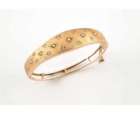 A GOLD, DIAMOND AND PEARL HALF HINGED BANGLE set to one side with gold granulated decoration mounted with circular-cut diamon