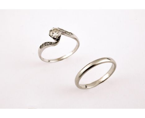 A DIAMOND SOLITAIRE RING the circular-cut diamond is set with five diamonds to each shoulder in 18ct white gold, size O 1/2, 