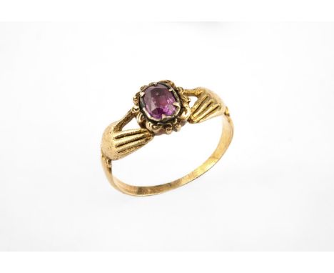 AN EARLY 19TH CENTURY GOLD AND GEM SET FEDE RING formed with two hands holding an oval-shaped foil backed ruby, in gold close