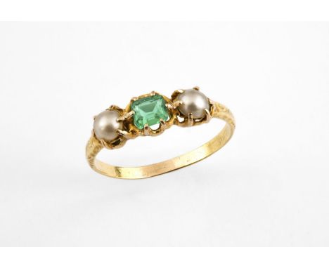 AN EMERALD AND PEARL THREE STONE RING the square-shaped emerald is set with two half pearls, in yellow gold. Size R 1/2