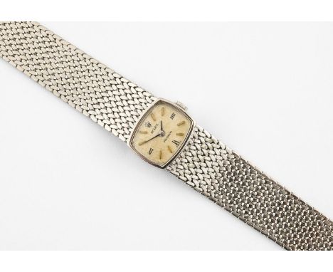 A LADY'S GOLD WRISTWATCH BY ROLEX the signed cushion-shaped dial with Roman and baton numerals, with Rolex motif to the winde