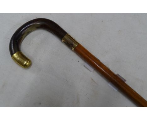 A walking stick with horn handle.