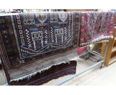 A red ground Persian design rug with building design panel, 157cm x 88cm approx. and a red ground Kelim design rug.