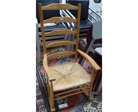 A Cotswold School ash ladder back rocking chair.