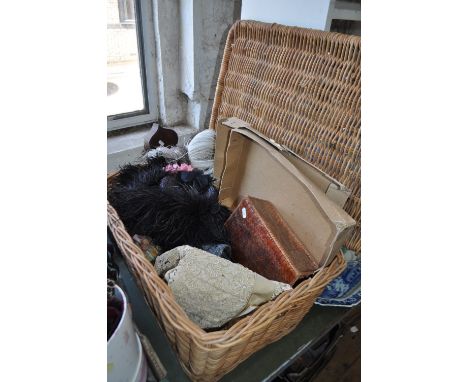 An Ekrew lacework dress, feather trimmed hat, crocodile skin handbag, etc., in a wicker hamper.