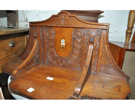 An Antique carved oak shelf bracket with inlaid ivory Armorial, length 82cm.