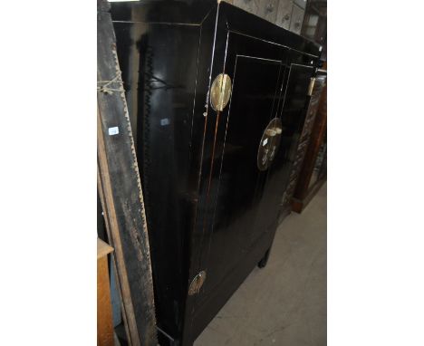 A Chinese black lacquered cabinet, with 2 panelled doors and drawer and shelf fitted interior, width 109cm, height 159cm, dep