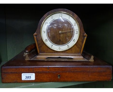 A mahogany cased fish cutlery, crumb tray and brush and a mantel clock.