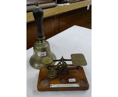 Postal scale and a bell with turned wood handle.