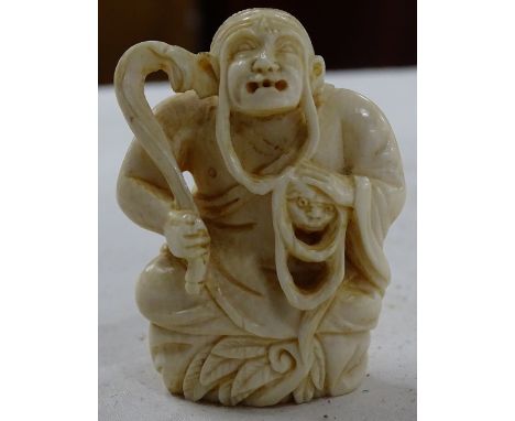 A Japanese carved netsuke, signed.