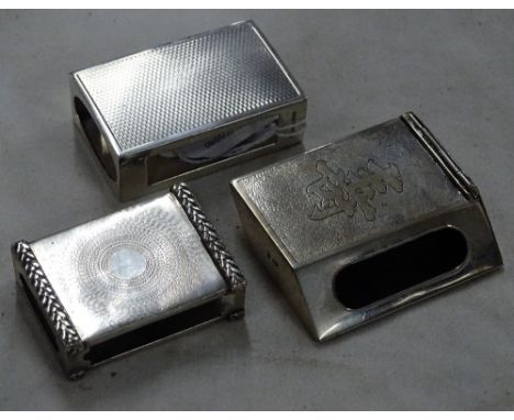 3 Various Oriental and English silver matchbox holders, largest length 6cm, (3).