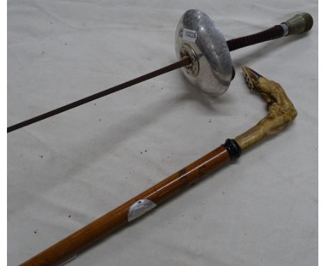 A fencing sabre and a walking stick with deer's foot handle.