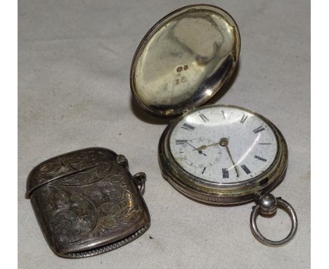 An engraved silver vesta and an engine turned silver full hunter pocket watch