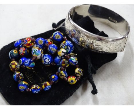 Engraved silver bangle and a coloured glass bead necklace
