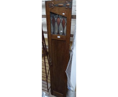 Pair of Art Nouveau oak panelled doors, with coloured lead light glazed panels and stylised copper hinges.